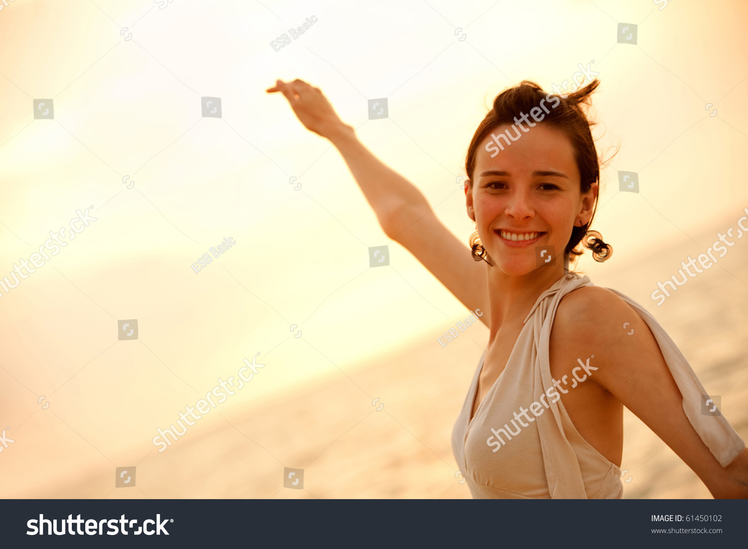 Portrait of a beautiful woman smiling at sunset outdoors #61450102