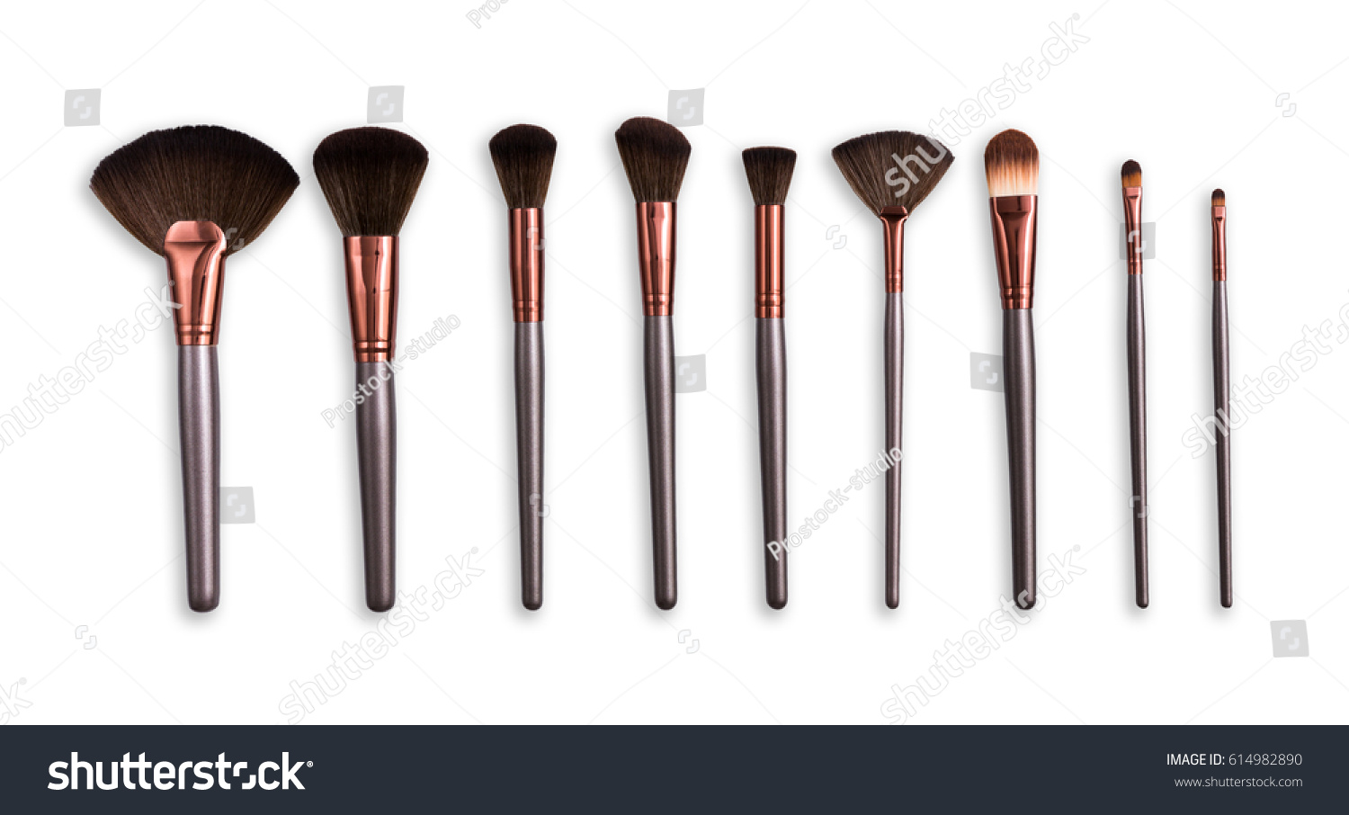 Cosmetics and beauty. Make-up brushes set in row on white isolated background #614982890