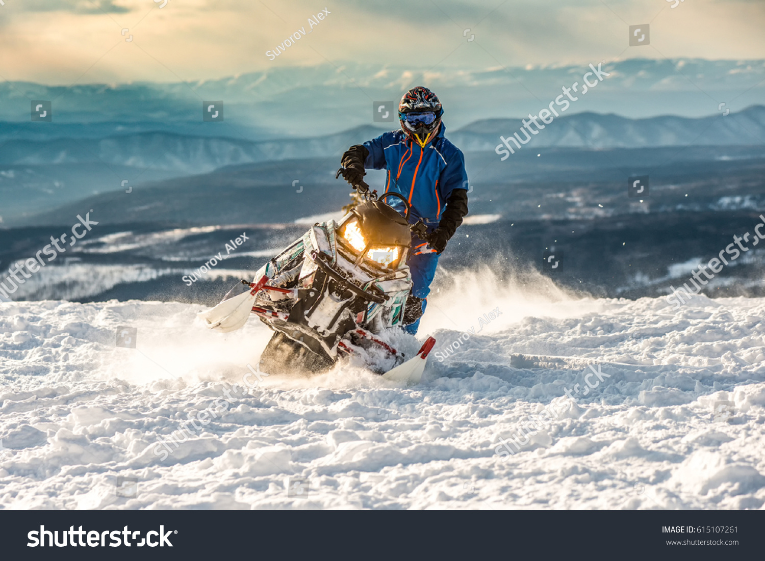 Rider on the snowmobile in the mountains ski resort in Amut Russia. #615107261