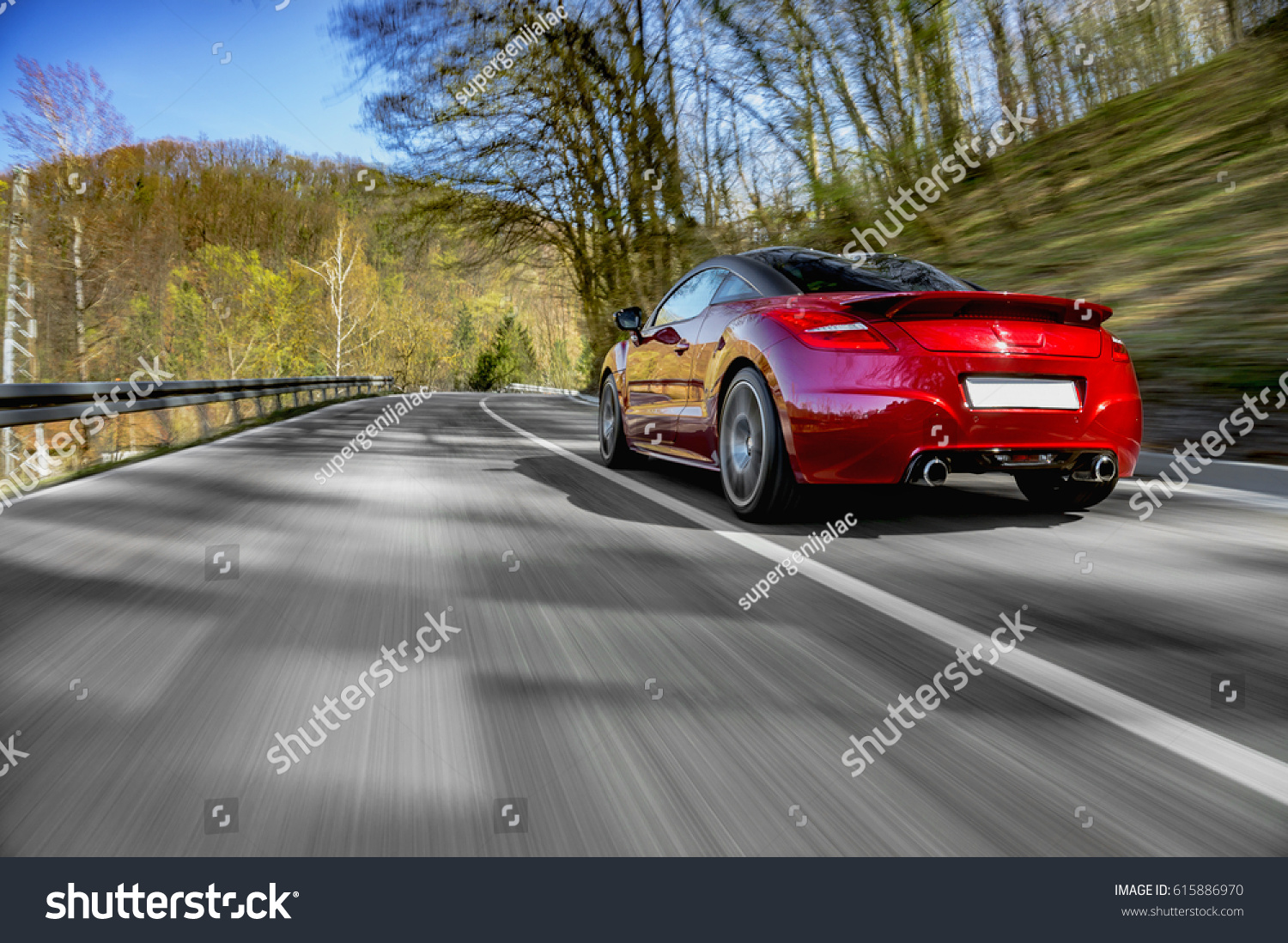 Generic red sports car driving fast on the open road #615886970