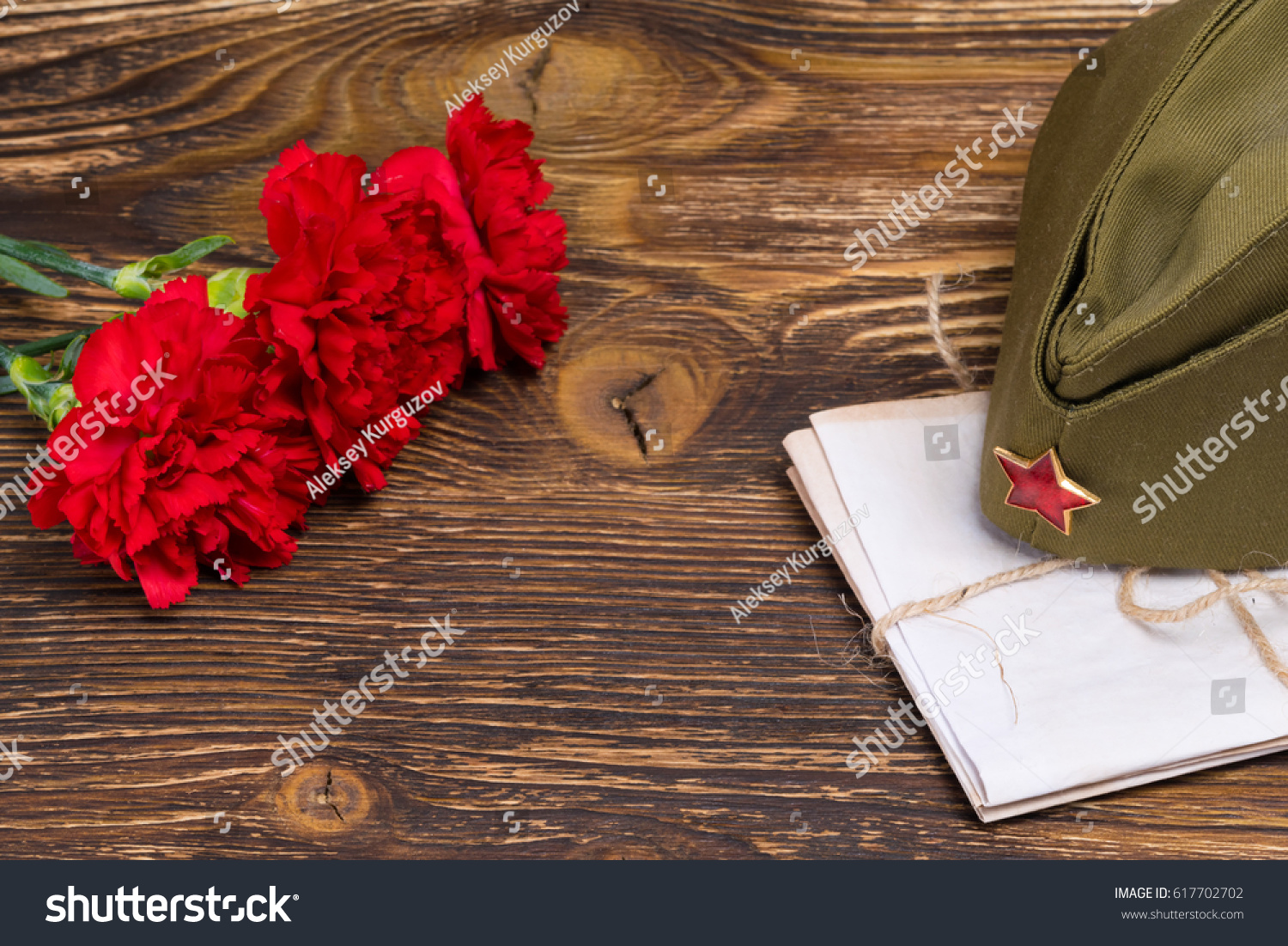 Military letters under the cap and three carnations in honor of May 9 #617702702