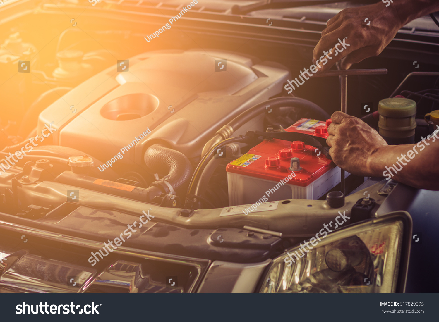 Car service ,fitting a car battery with wrench / soft focus picture  #617829395