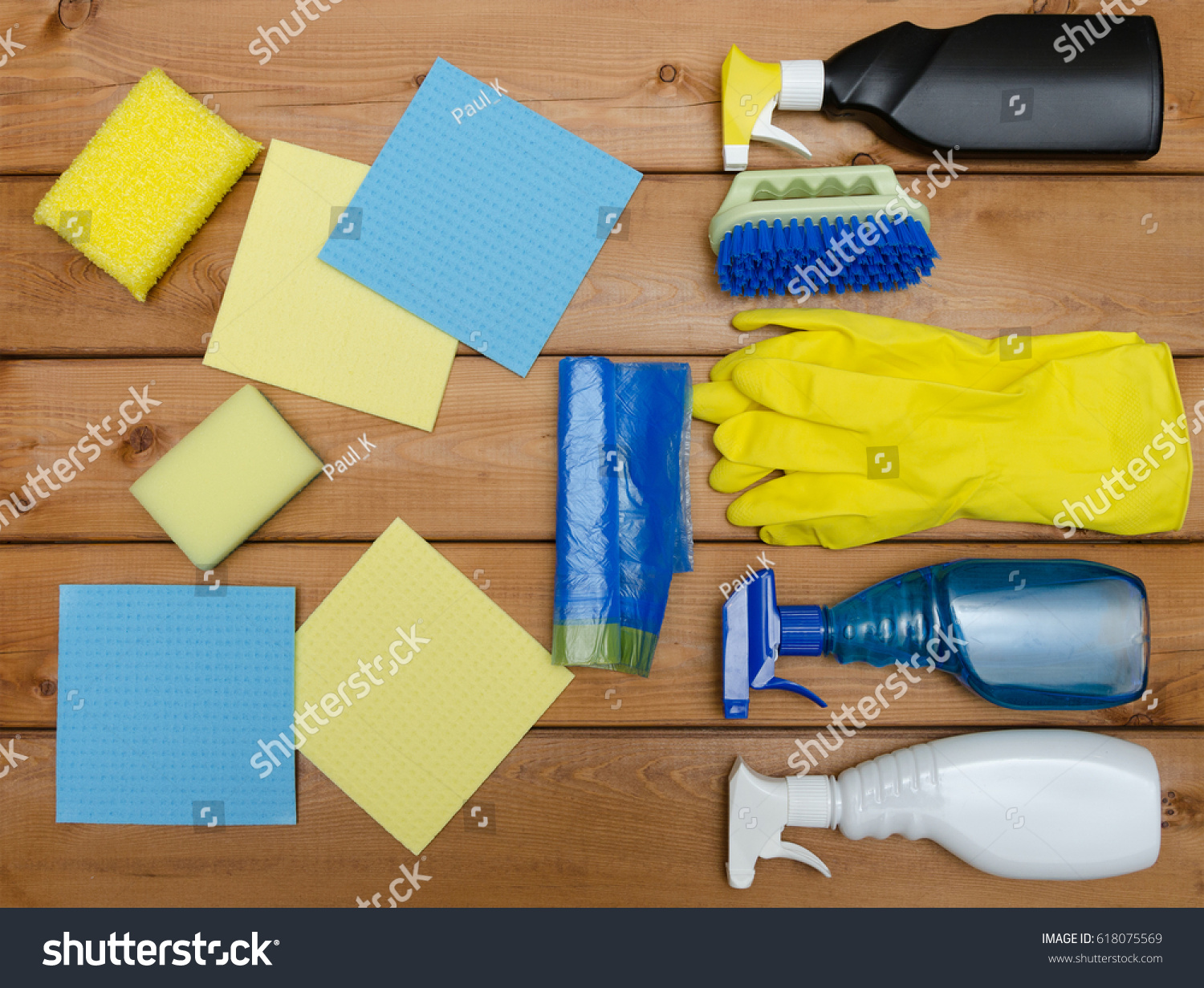 Set of variety cleaning supplies on wooden table #618075569