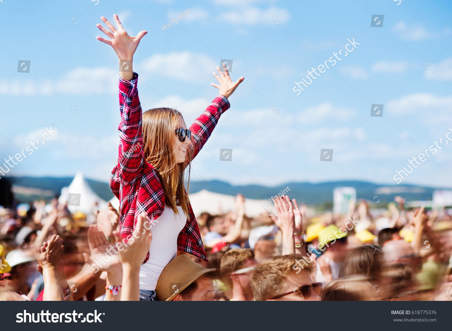 Teenagers at summer music festival enjoying themselves #618775376