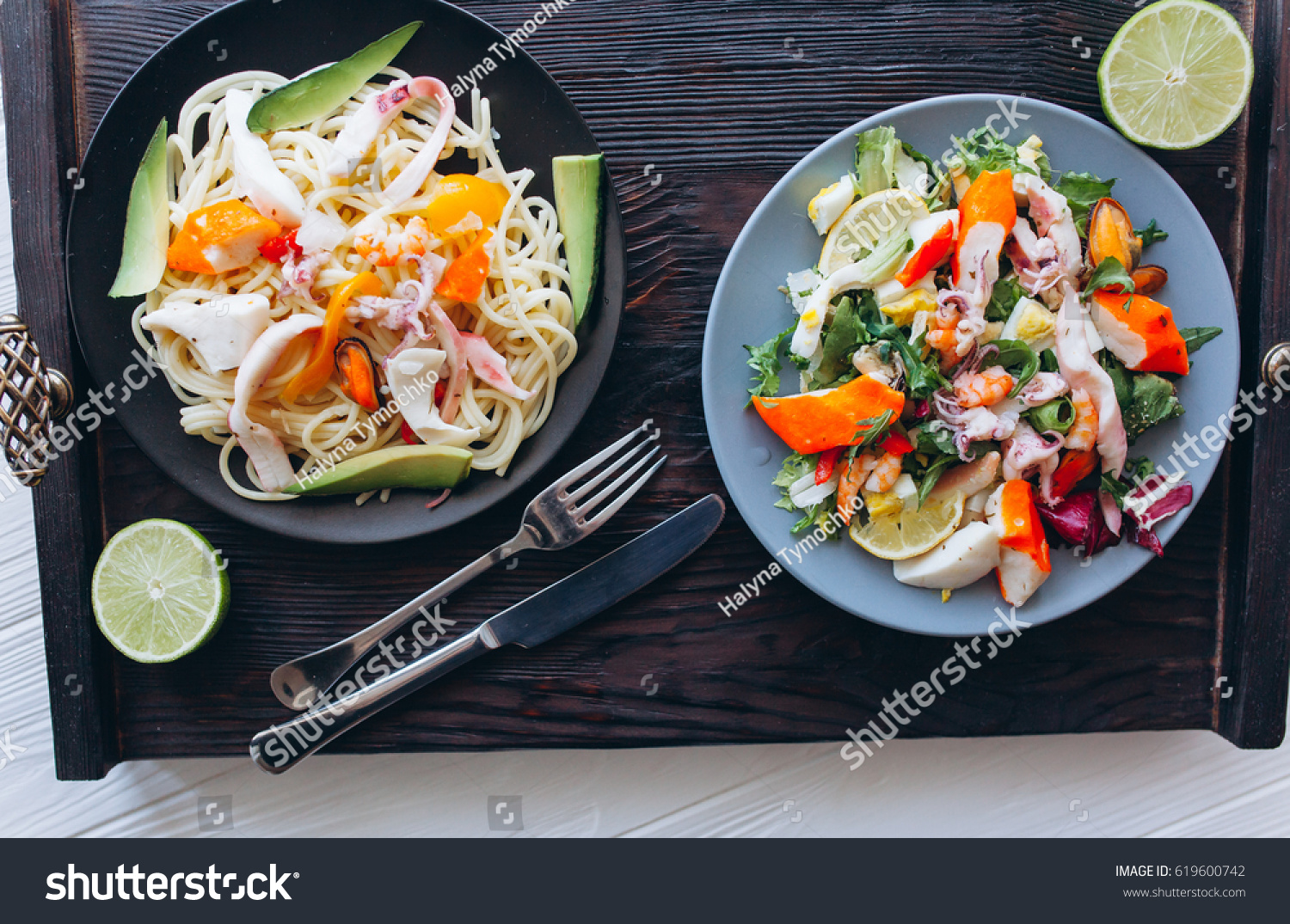 salad and pasta with seafood on wooden background #619600742