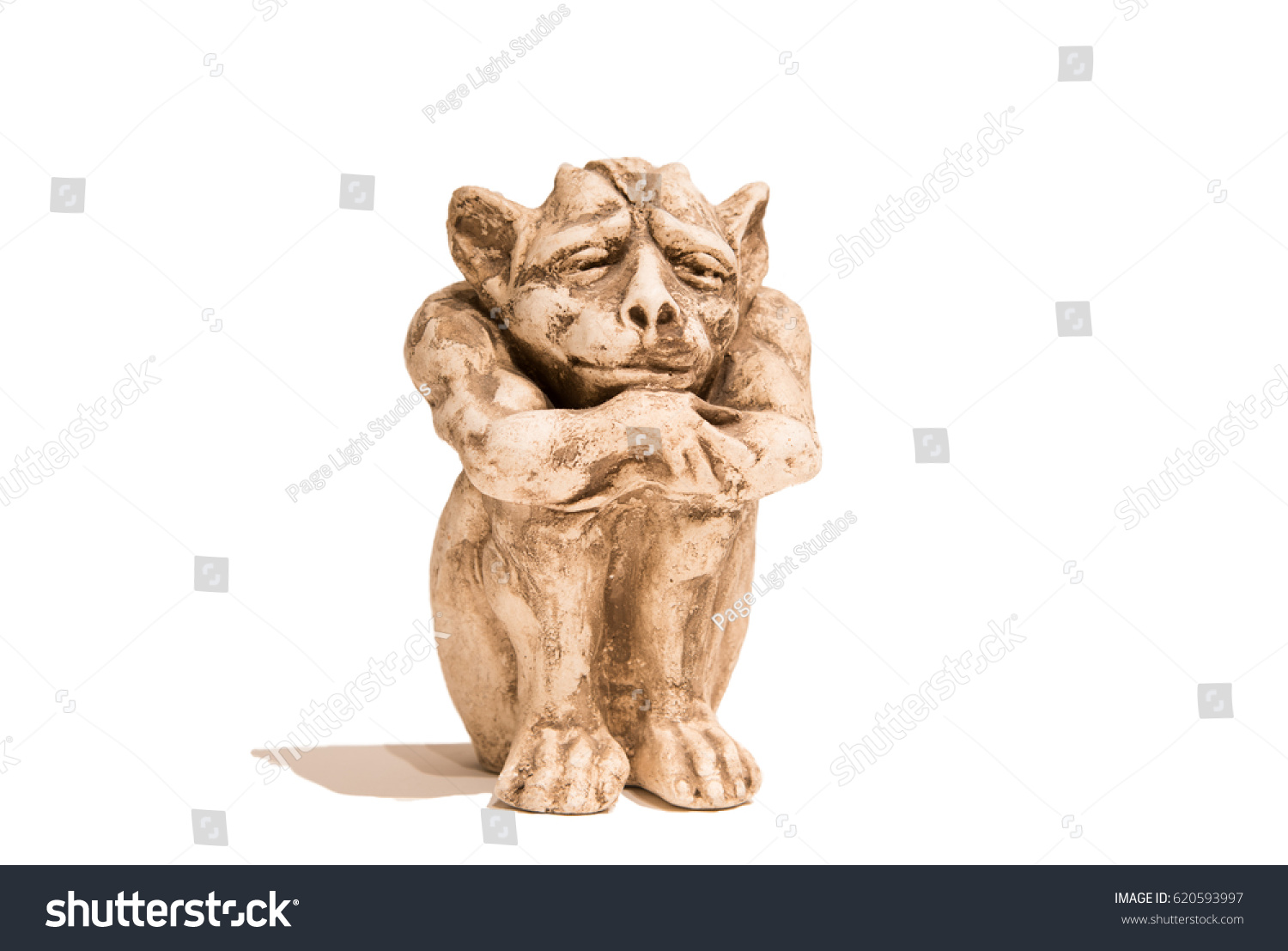Isolated sitting gargoyle figurine on white background. With shadow. #620593997
