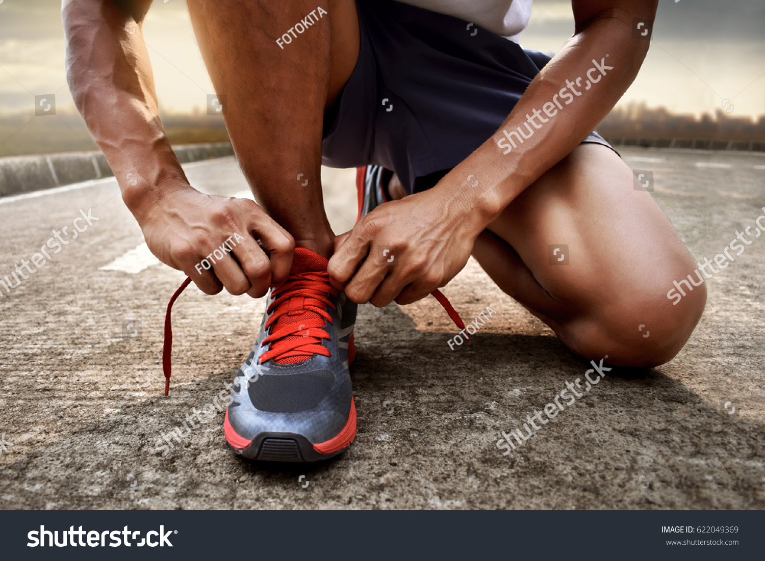 Man tying running shoes #622049369