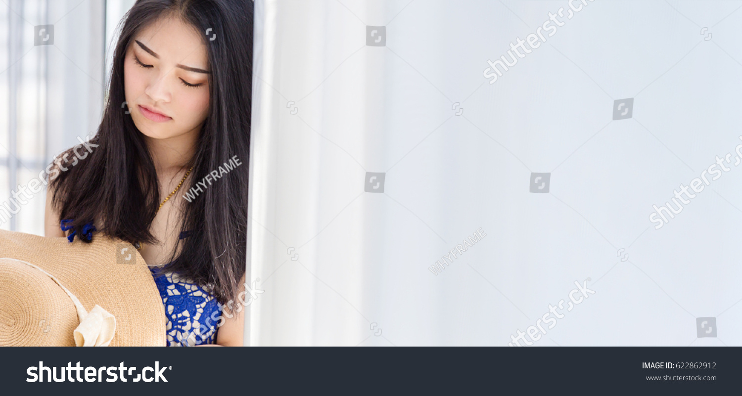 cute asian gril with summer dress and hat with relaxing pose with white room background #622862912