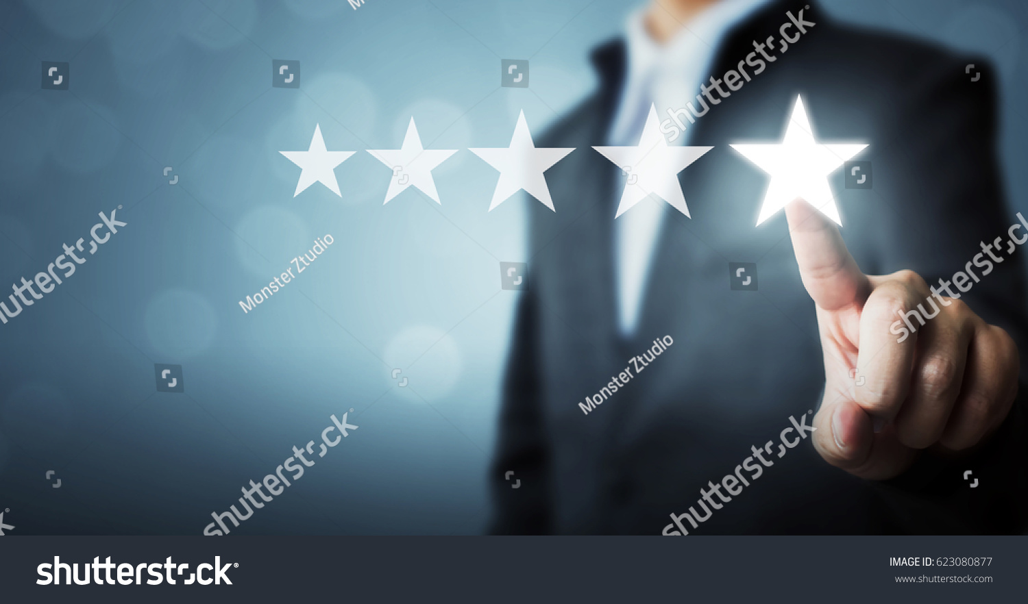 Businessman pointing five star symbol to increase rating of company #623080877
