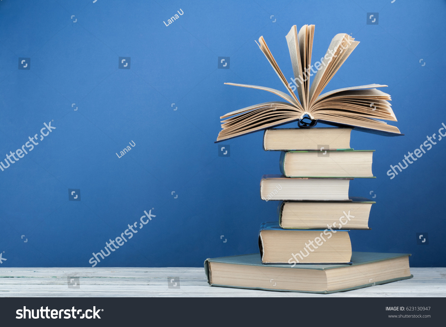 Stack of colorful books. Education background. Back to school. Book, hardback colorful books on wooden table. Education business concept. Copy space for text #623130947