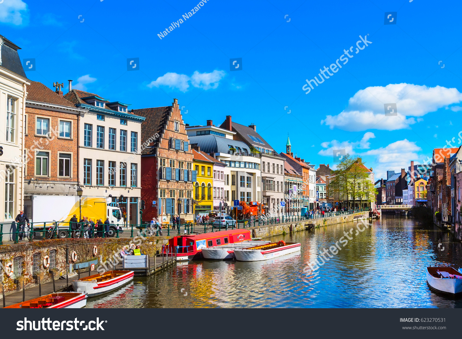 old colorful traditional houses along the canal and boats in popular touristic destination Ghent, Belgium #623270531