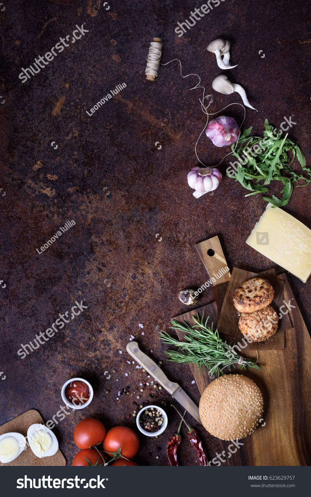 Burger with meat, cheese and fresh vegetables. On a wooden board. Top view, copy space. #623629757