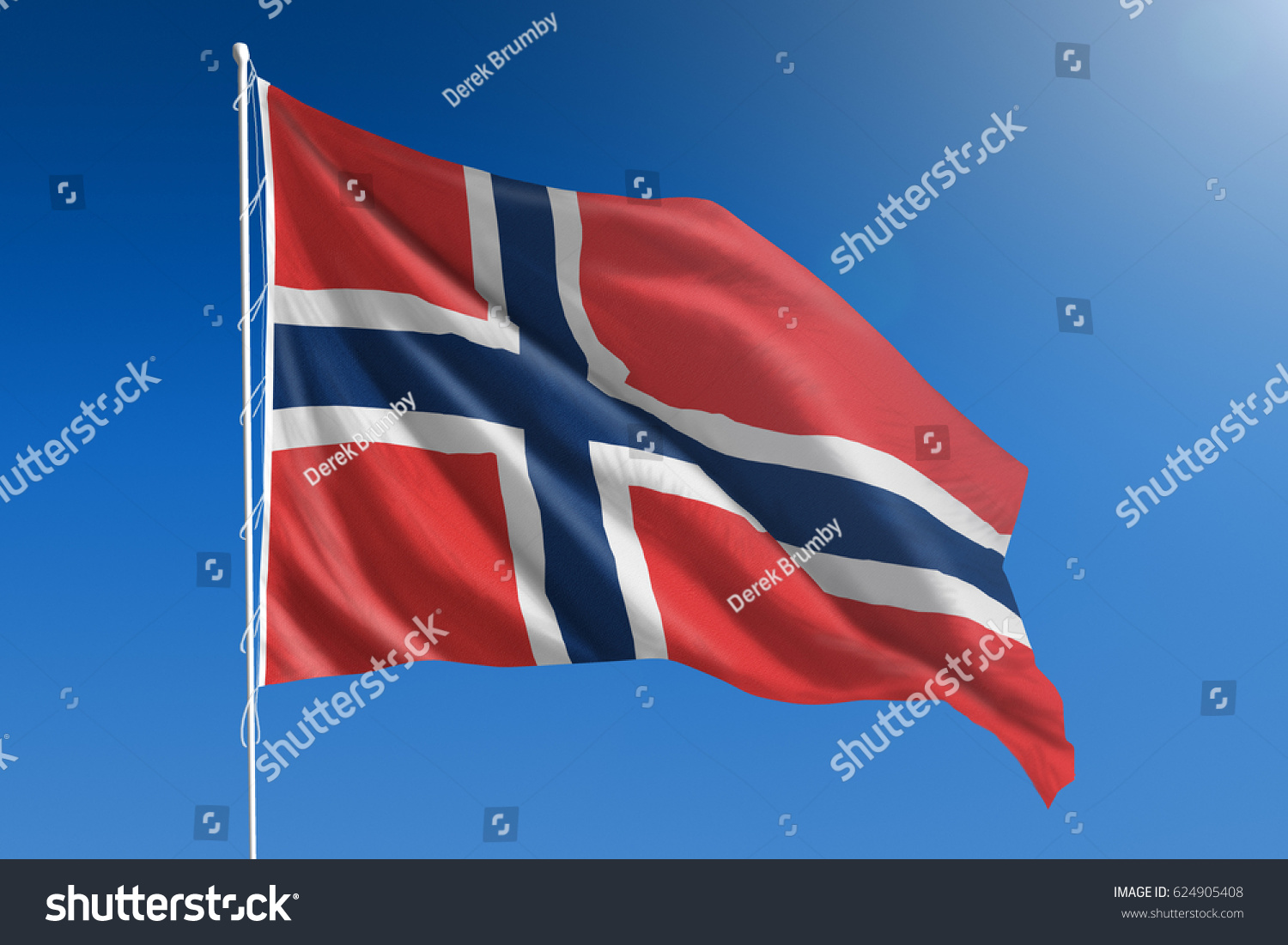 The National flag of Norway blowing in the wind in front of a clear blue sky #624905408