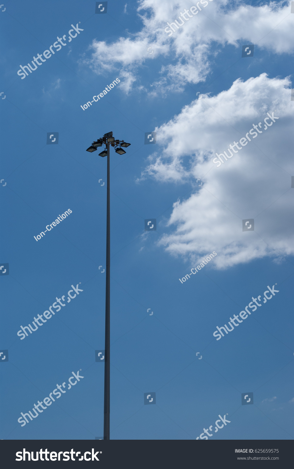 lighting pole under a bright blue sky #625659575