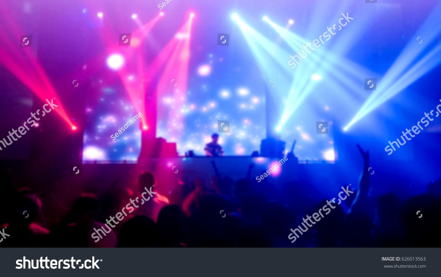 DJ turns  music people dancing in night club   photo blur #626013563
