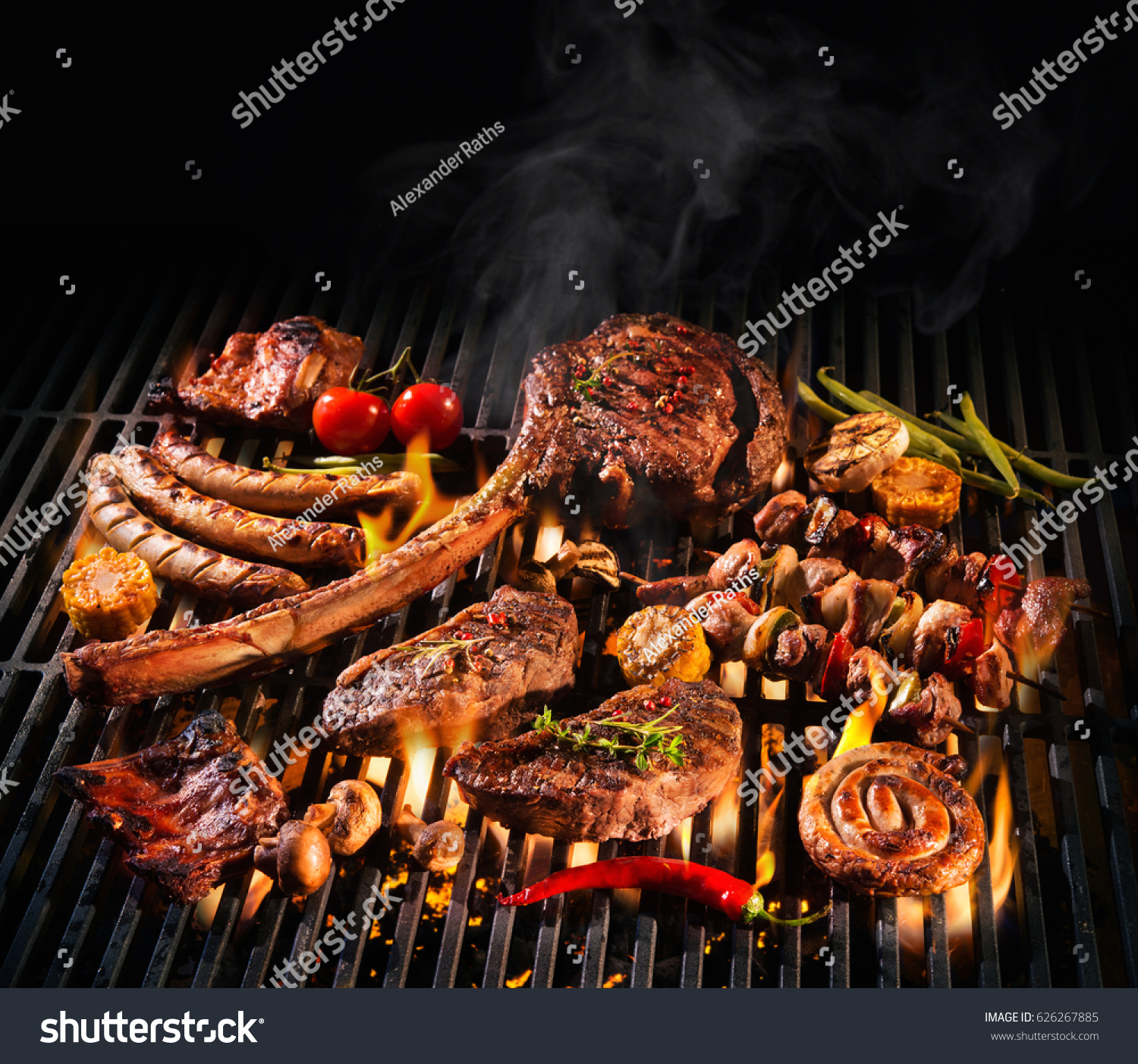 Assorted delicious grilled meat with vegetables over the coals on a barbecue #626267885