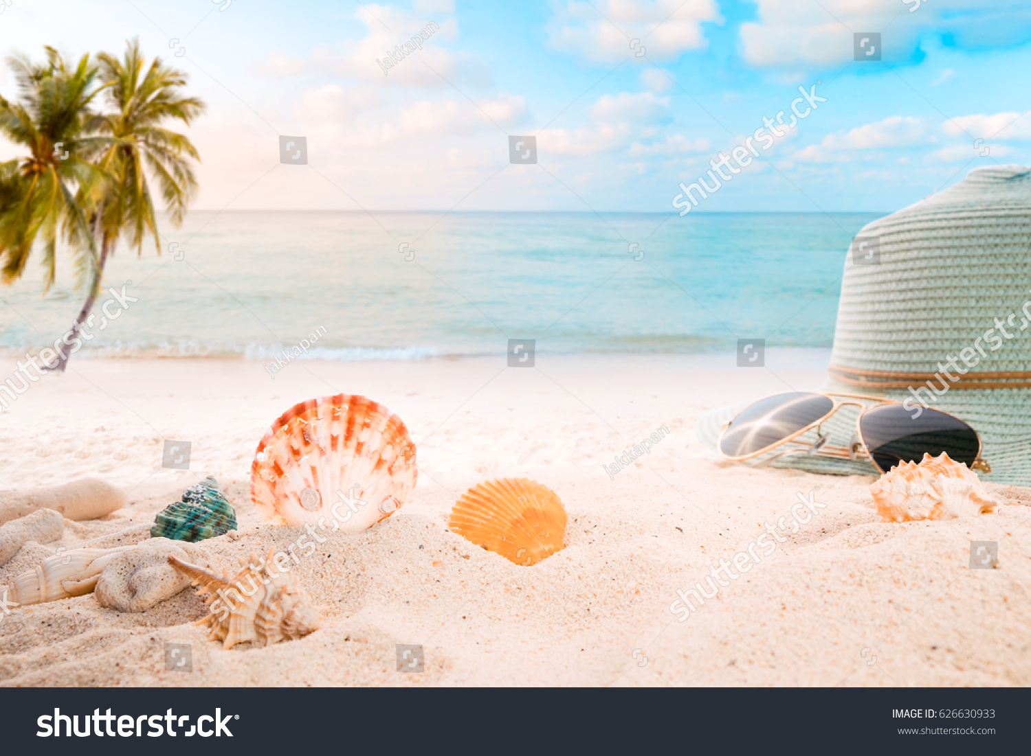 Summer accessories on sandy in seaside summer beach with starfish, shells, coral on sandbar and blur sea background. Concept of recreation in summertime on tropical beach.  vintage color tone styles. #626630933