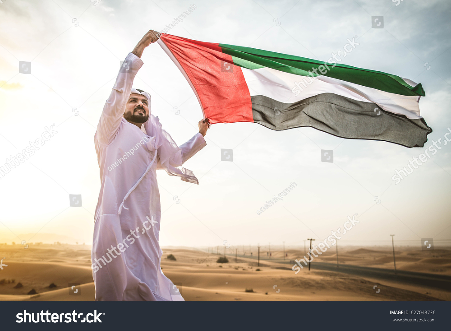 Arabian man walking  in the desert at sunrise #627043736