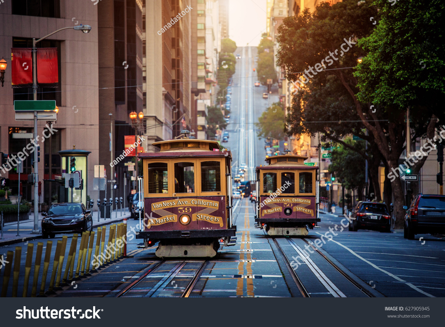 Classic view of historic traditional Cable Cars riding on famous California Street in morning light at sunrise with retro vintage style cross processing filter effect, San Francisco, California, USA #627905945