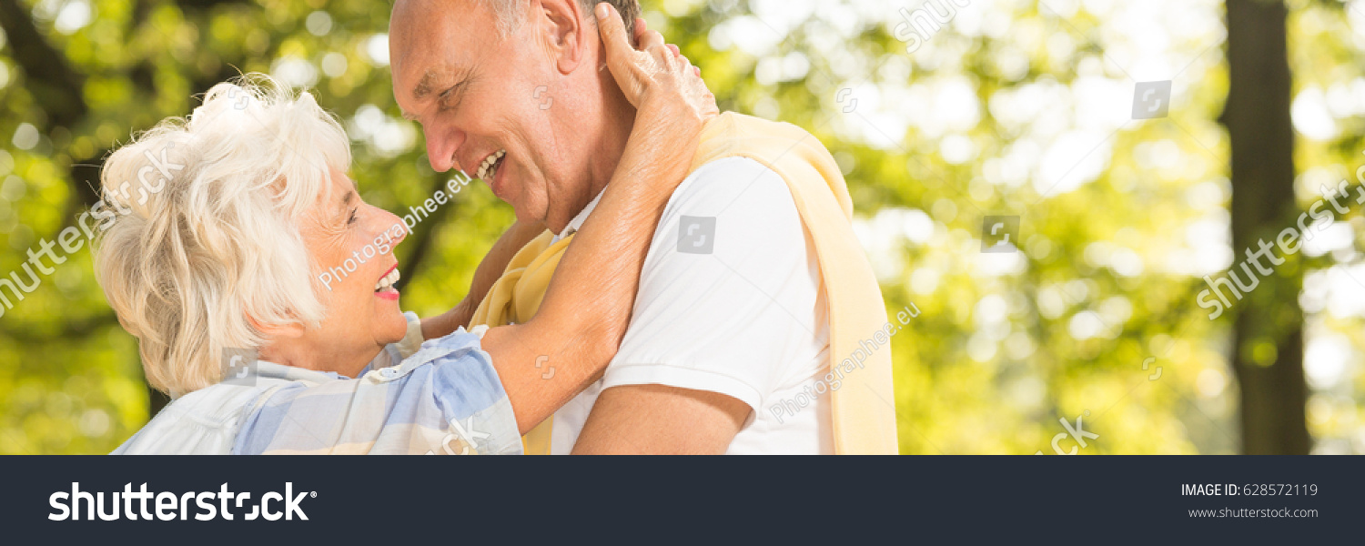 Happy senior couple hugging and looking each other in the eyes in a park #628572119