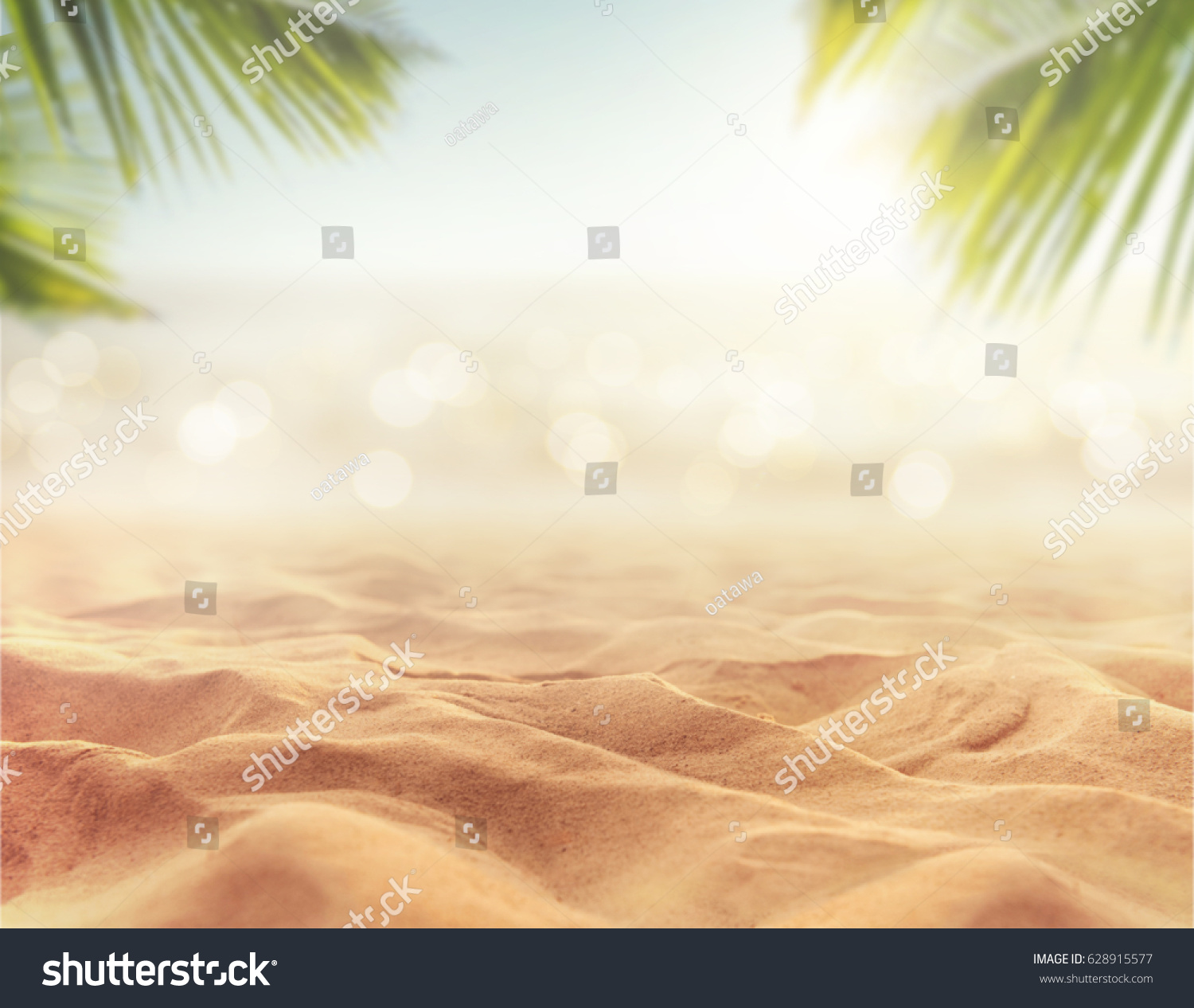 Sand with blurred Palm and tropical beach bokeh background, Summer vacation and travel concept. Copy space #628915577