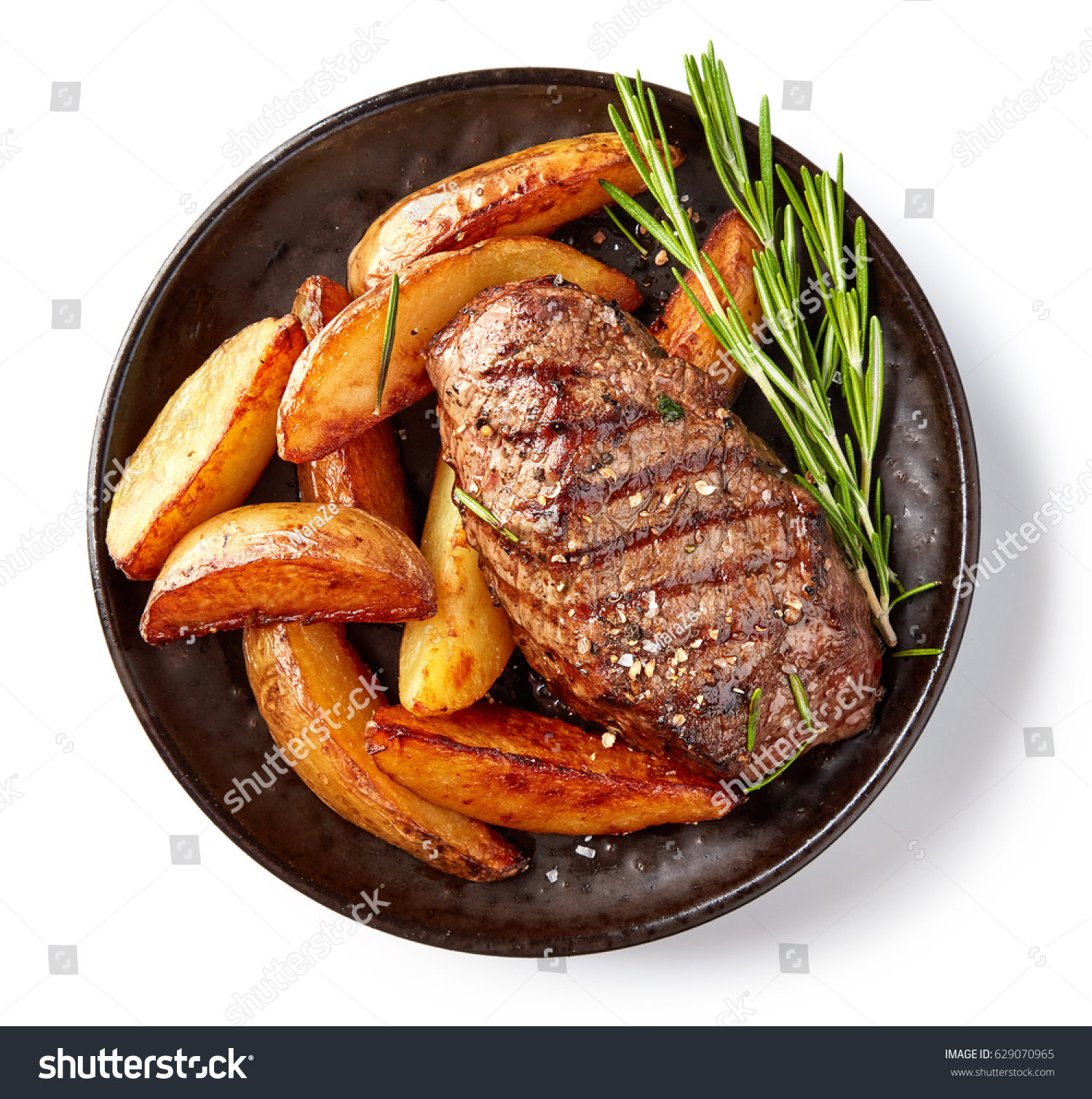 grilled beef steak and potatoes on plate isolated on white background, top view #629070965