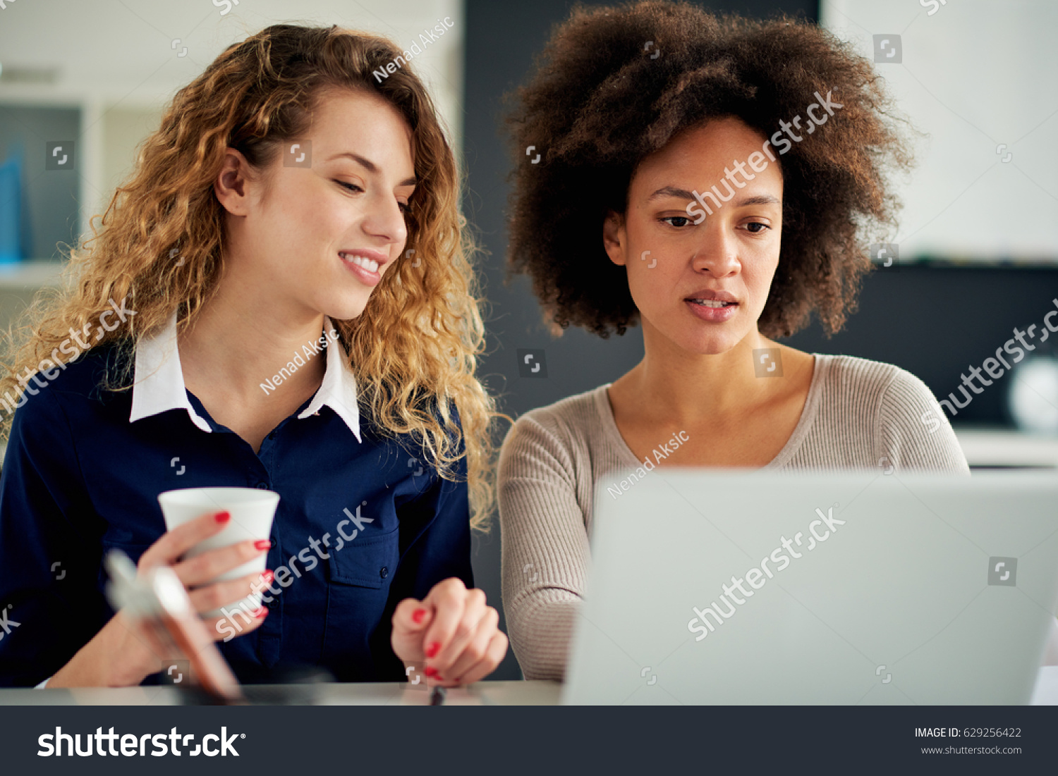 Two young women working on the laptop #629256422