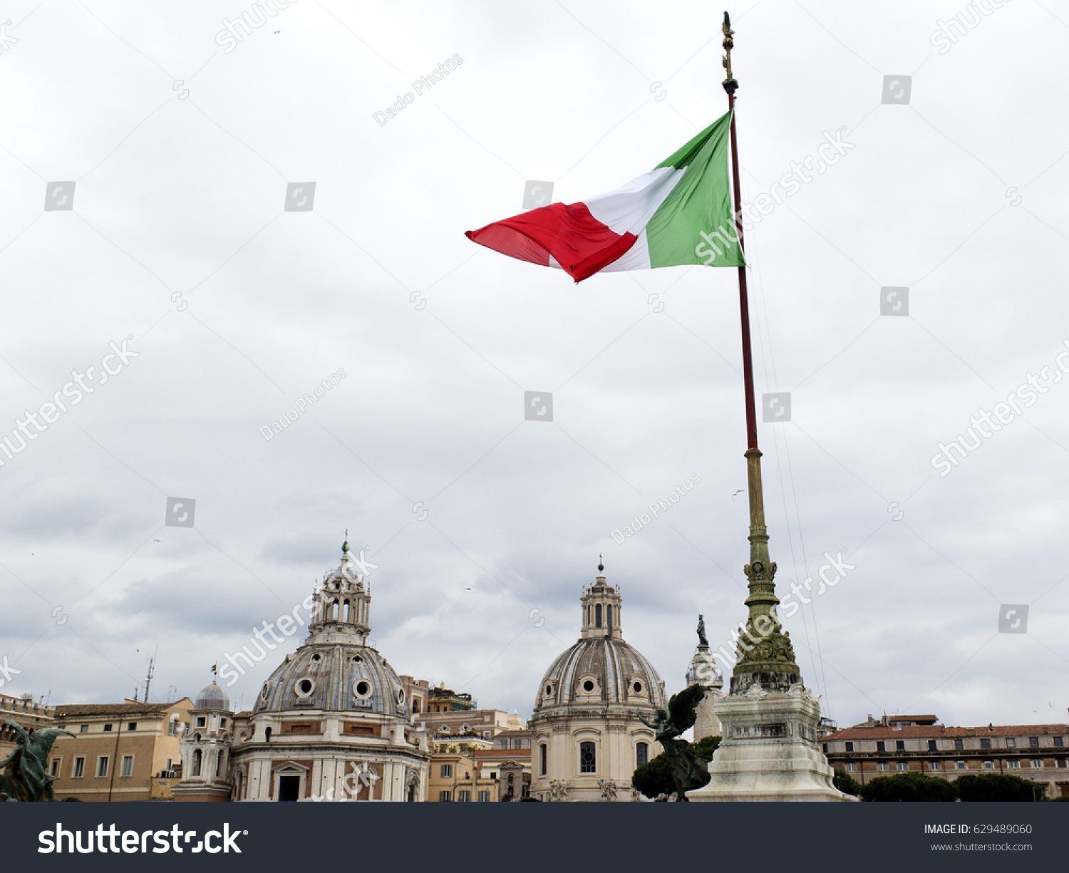 View of Rome, Italy. Flag and domes.  #629489060