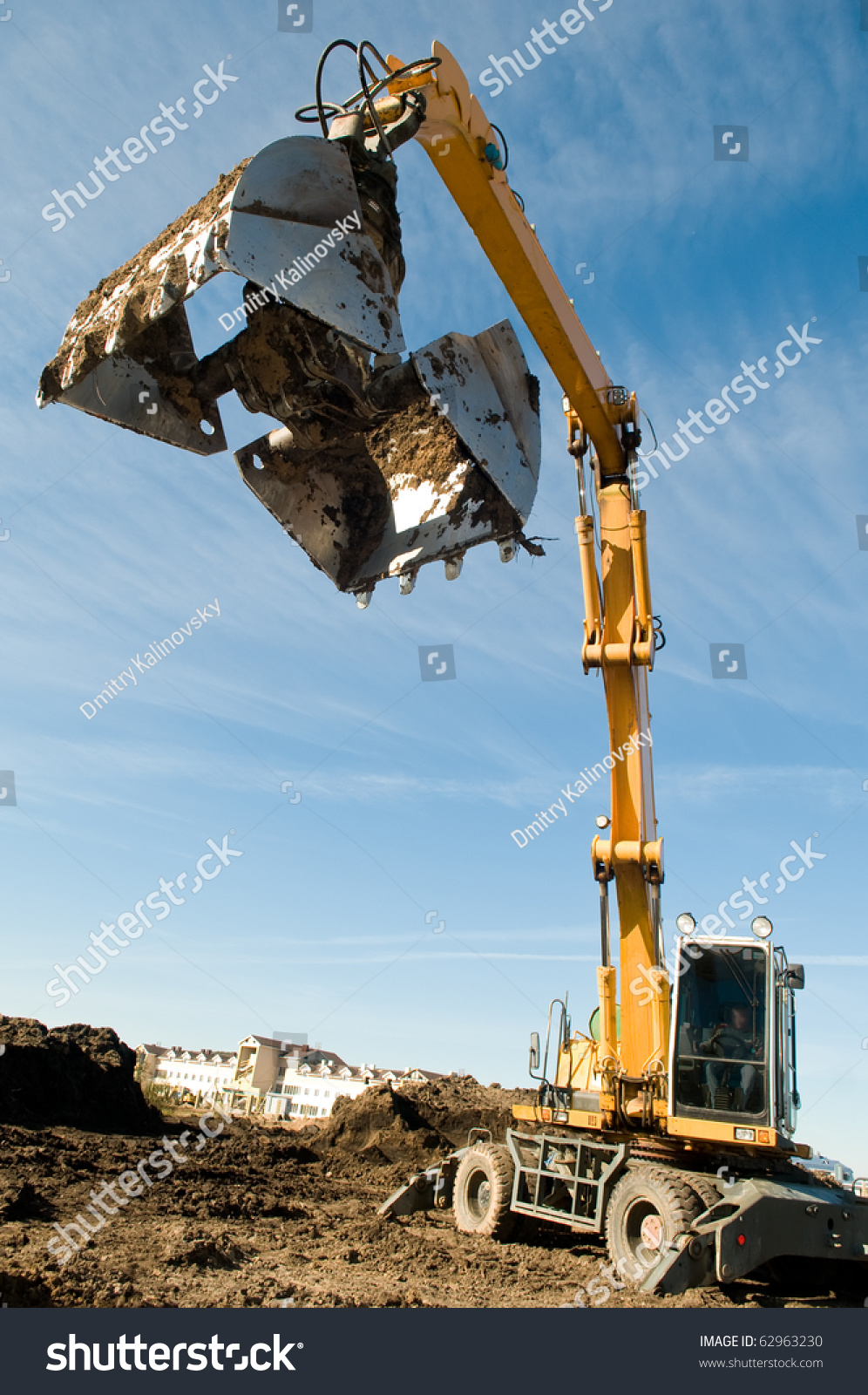 excavator loader machine during earthmoving works outdoors at construction site #62963230