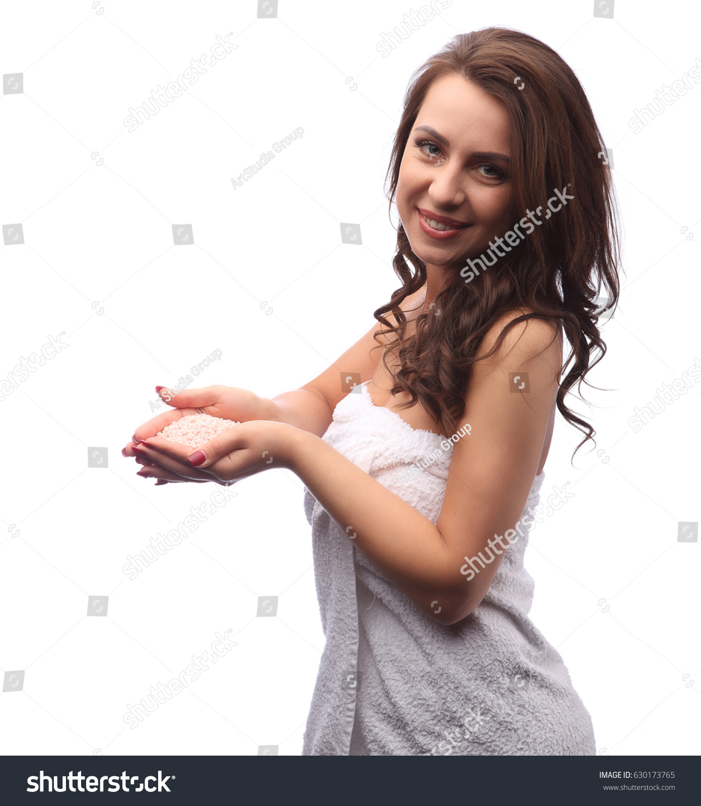 Young woman with pink bathing salt in white towel #630173765