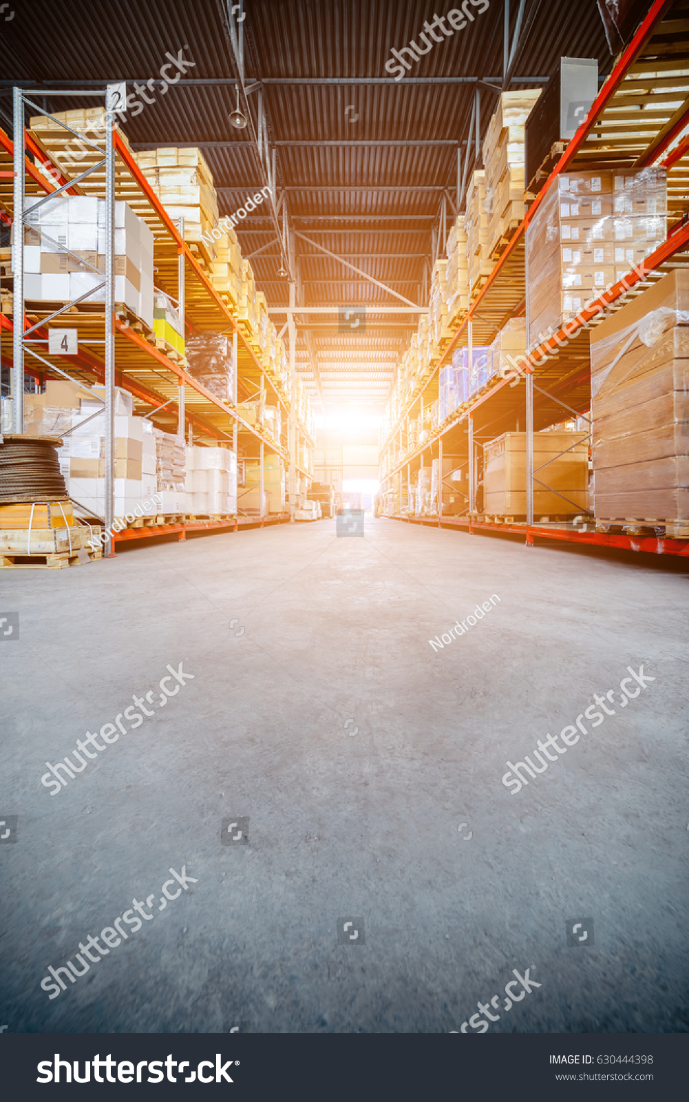 Warehouse industrial and logistics companies. Long shelves with a variety of boxes and containers. Toning the image. Bright sunlight. #630444398