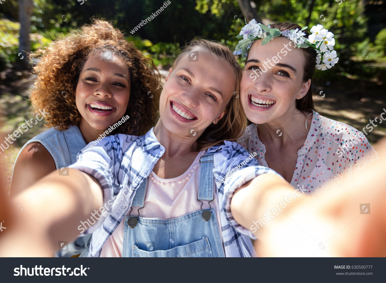 Female friends having fun in park on a sunny day #630500777