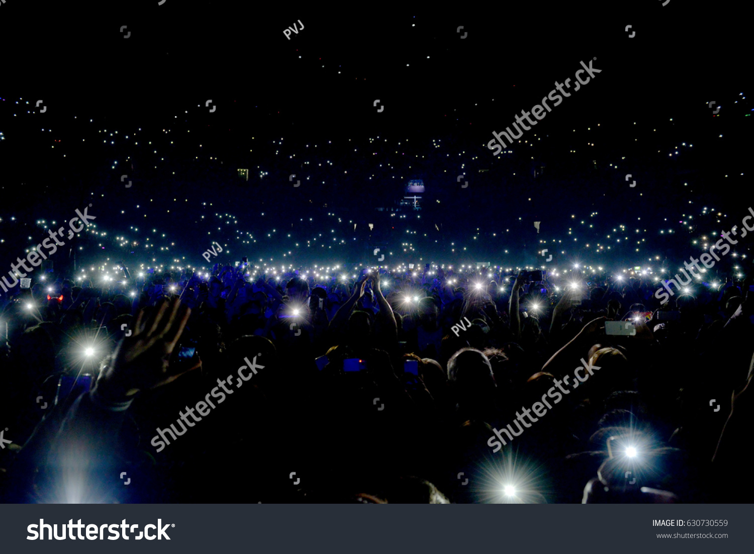 Crowd at concert with lights and camera flash on #630730559