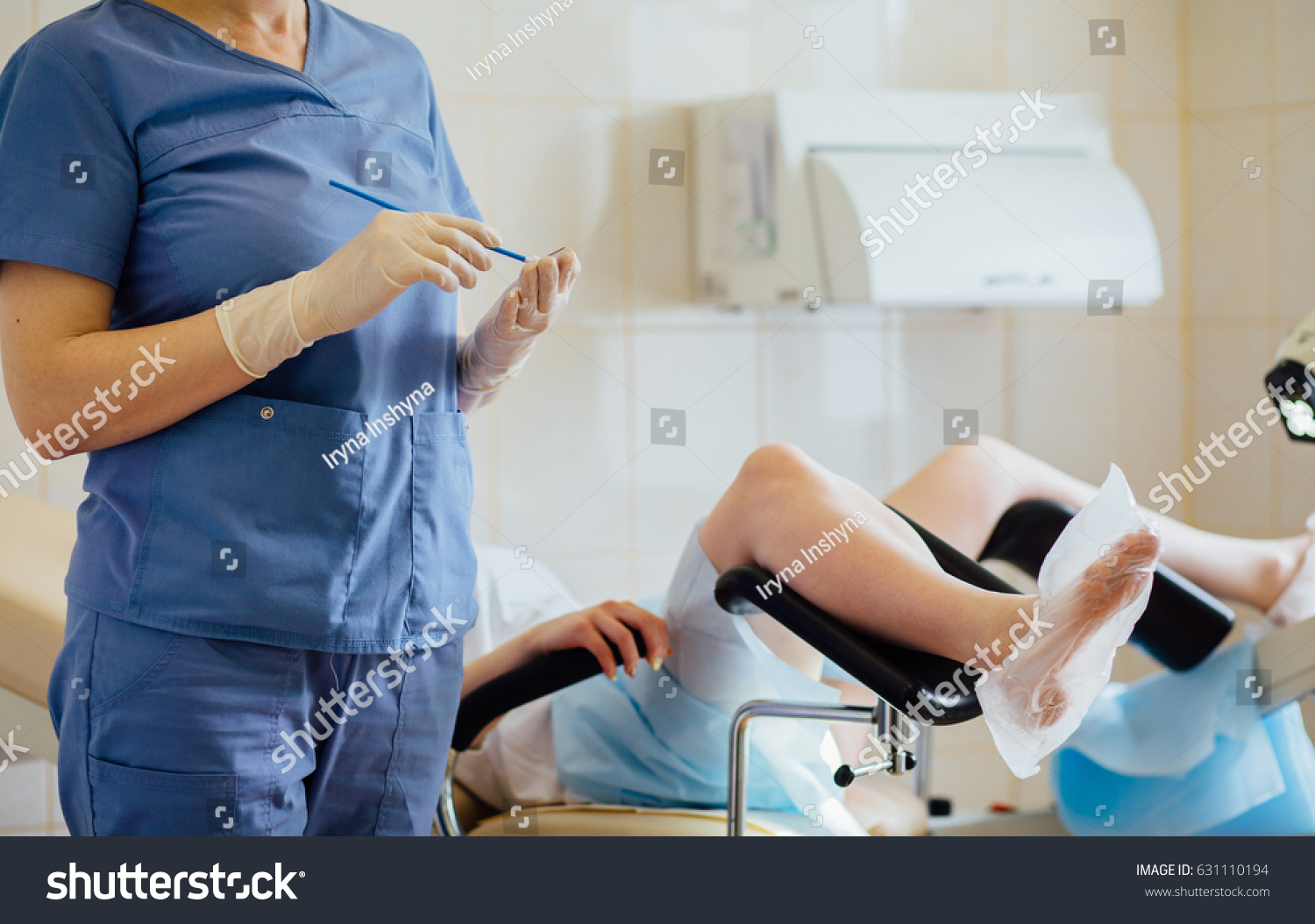 Unrecognizable female doctor gynecologist working with patient. Vaginal Smear. #631110194