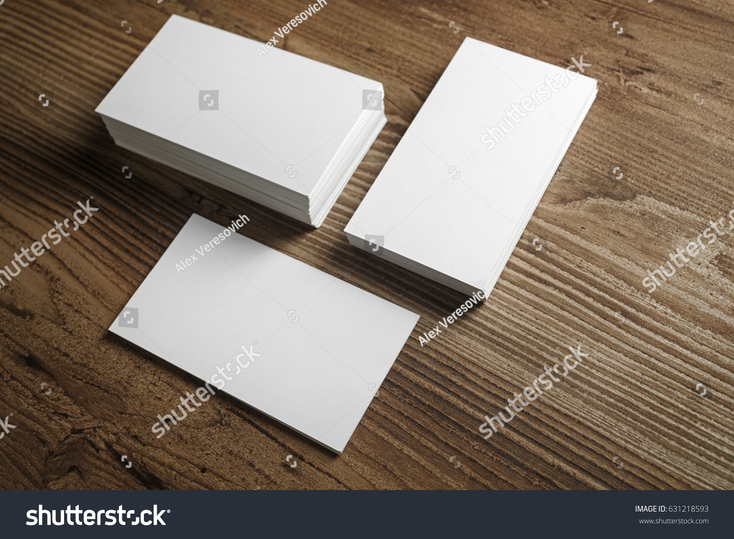 Photo of blank business cards on a wooden table background. Template for ID. #631218593