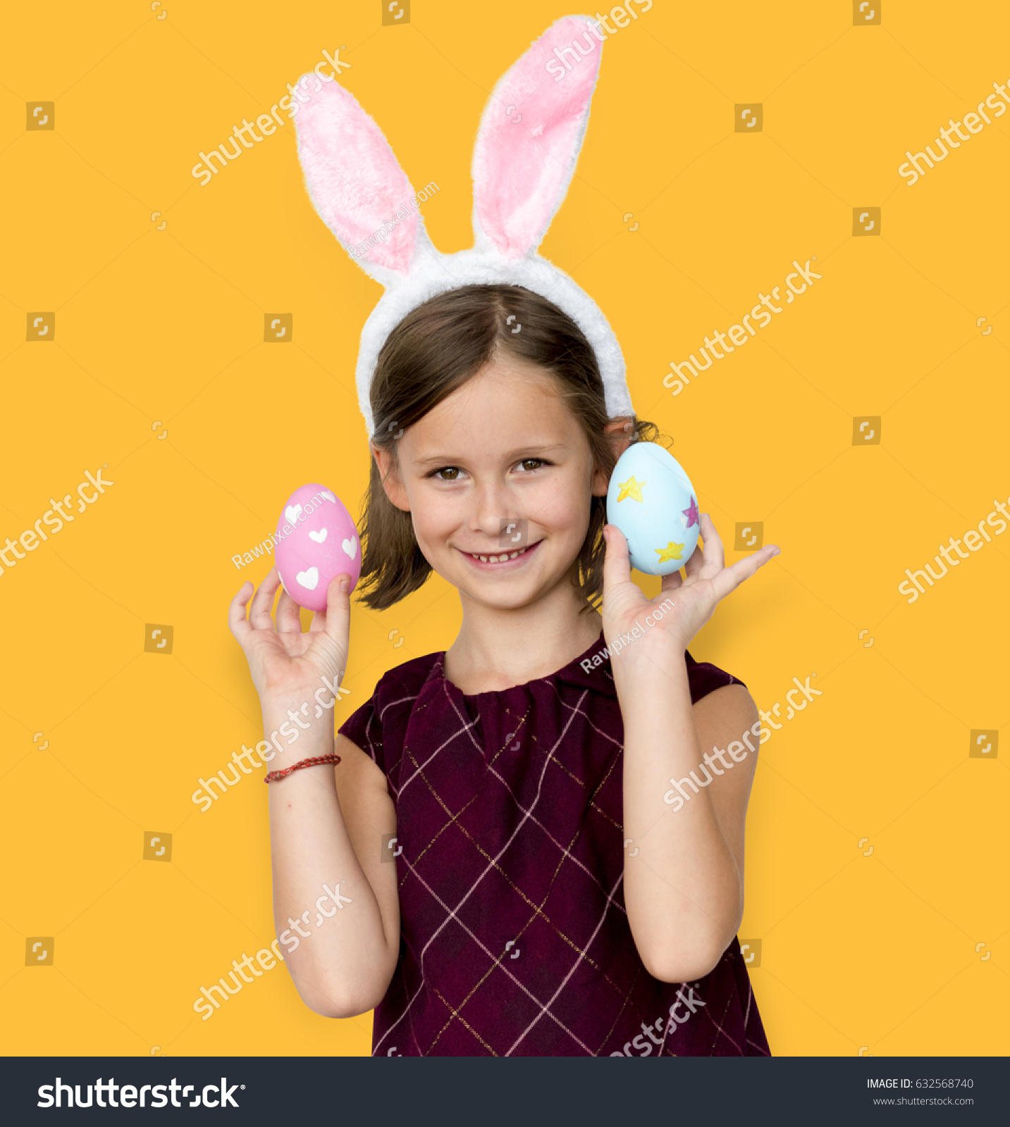 Kid with a bunny hairband holding eggs #632568740