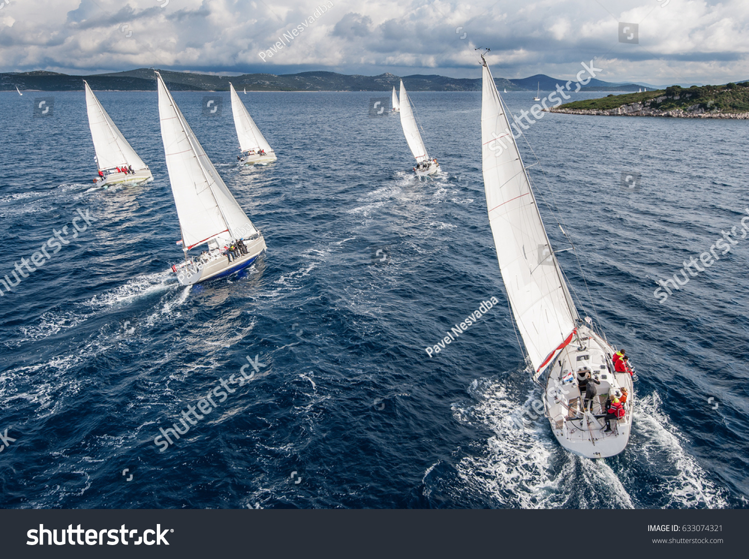 Fleet of sailing boats during offshore race from bird view #633074321