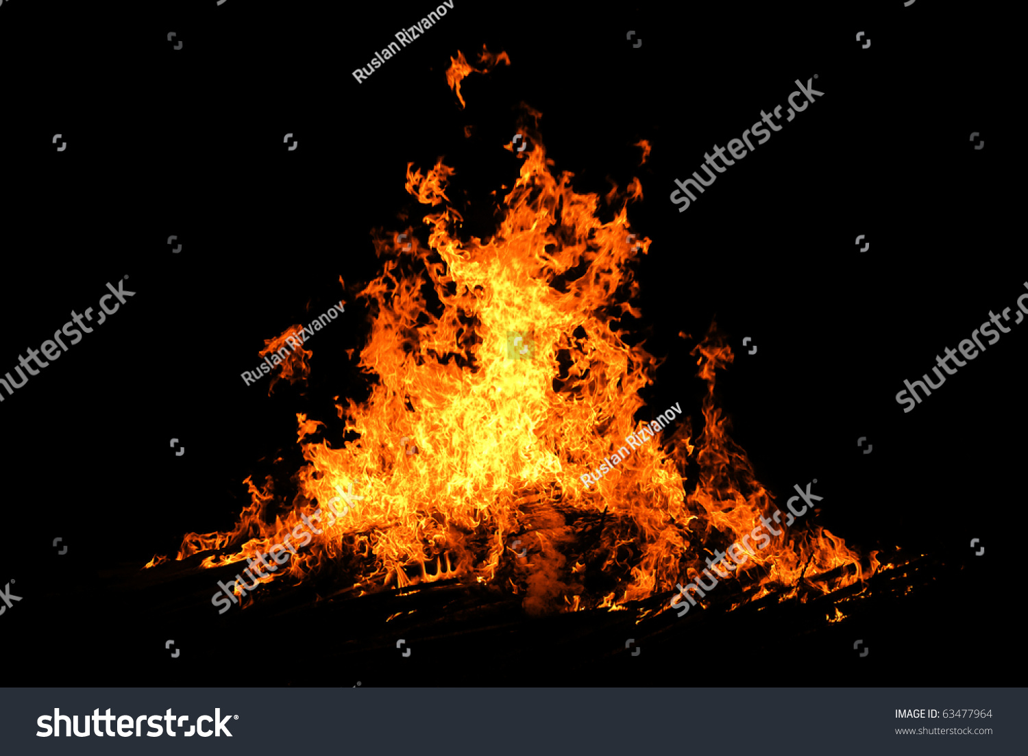 Night bonfire orange hot flames on black background in the night #63477964