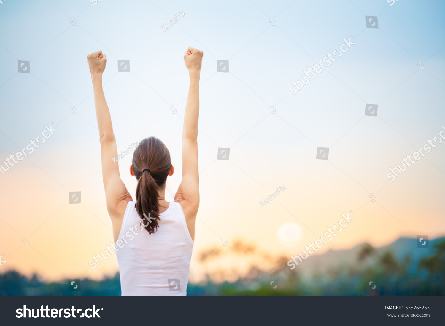 Success and life goals concept. Strong and confident woman with arms in the air.  #635268263