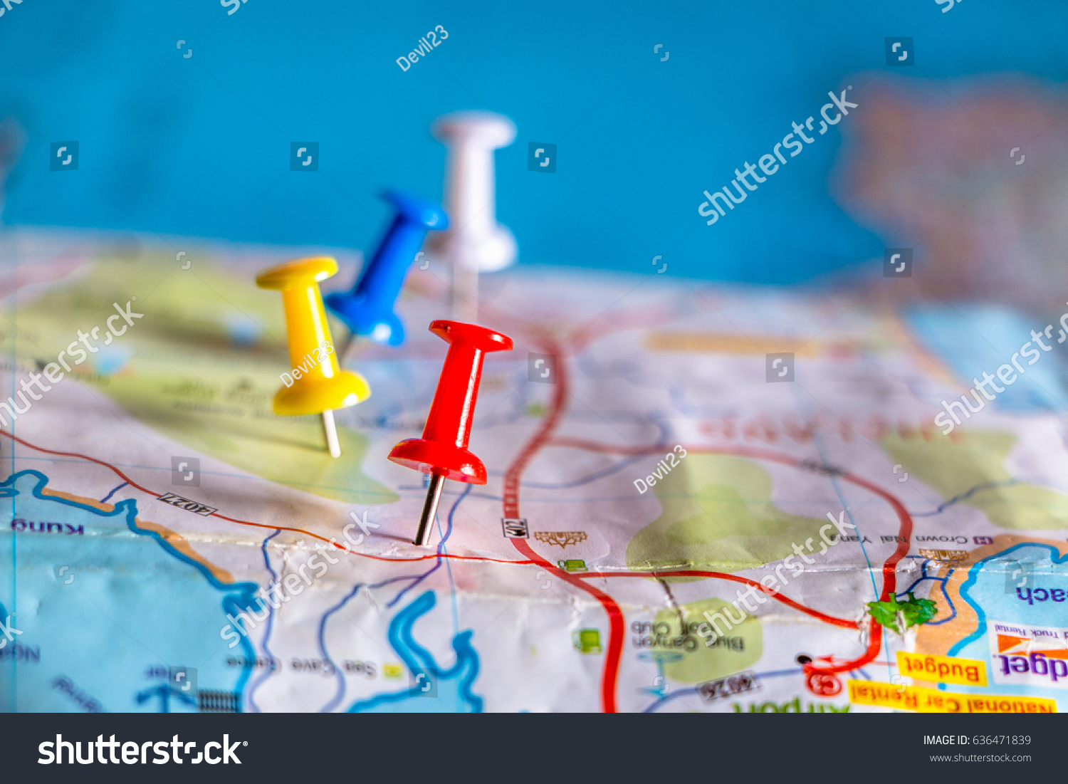 Travel destination pin points on a map with colorful thumbtacks and depth of field with select focus. #636471839