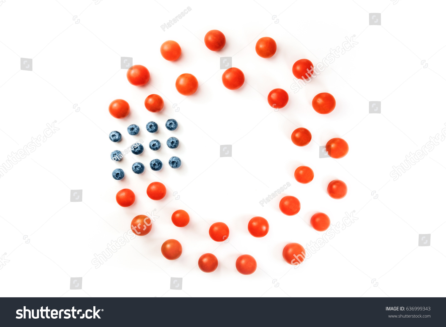 Cherry tomatoes and blueberries on white background, forming a frame for copy space. Culinary still life in colors of American flag. Independence Day or Memorial Day greeting card, 4th of July banner #636999343