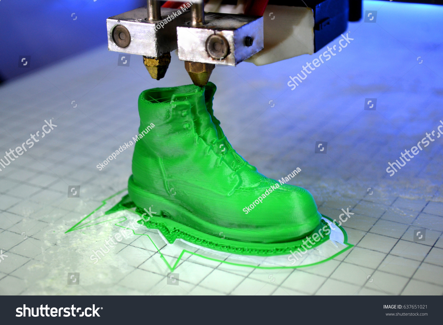 3D printer prints the form of molten plastic green close-up. Automatic three dimensional 3d printer performs plastic modeling in laboratory. Progressive modern additive technology #637651021