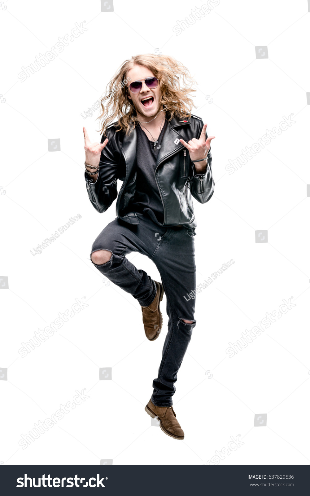portrait of handsome rocker in black leather jacket and sunglasses showing rock signs isolated on white, rock star concept #637829536