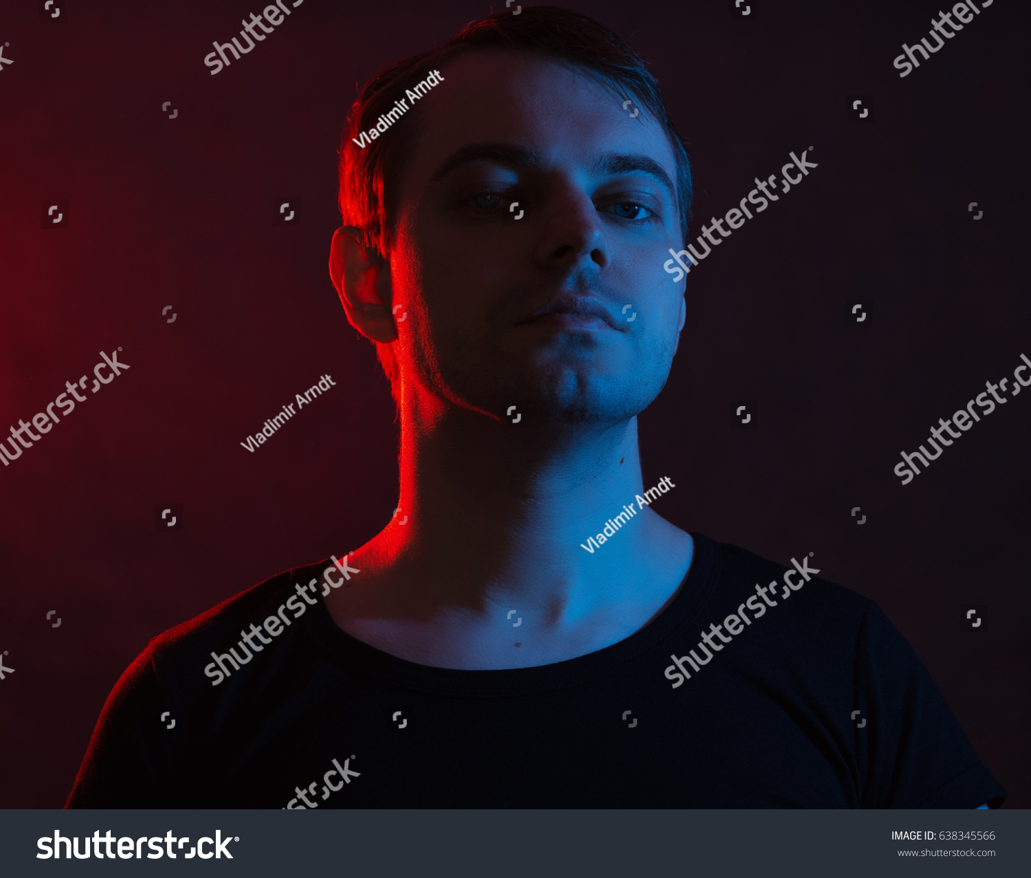 Portrait of a man with colored light and dark background. #638345566