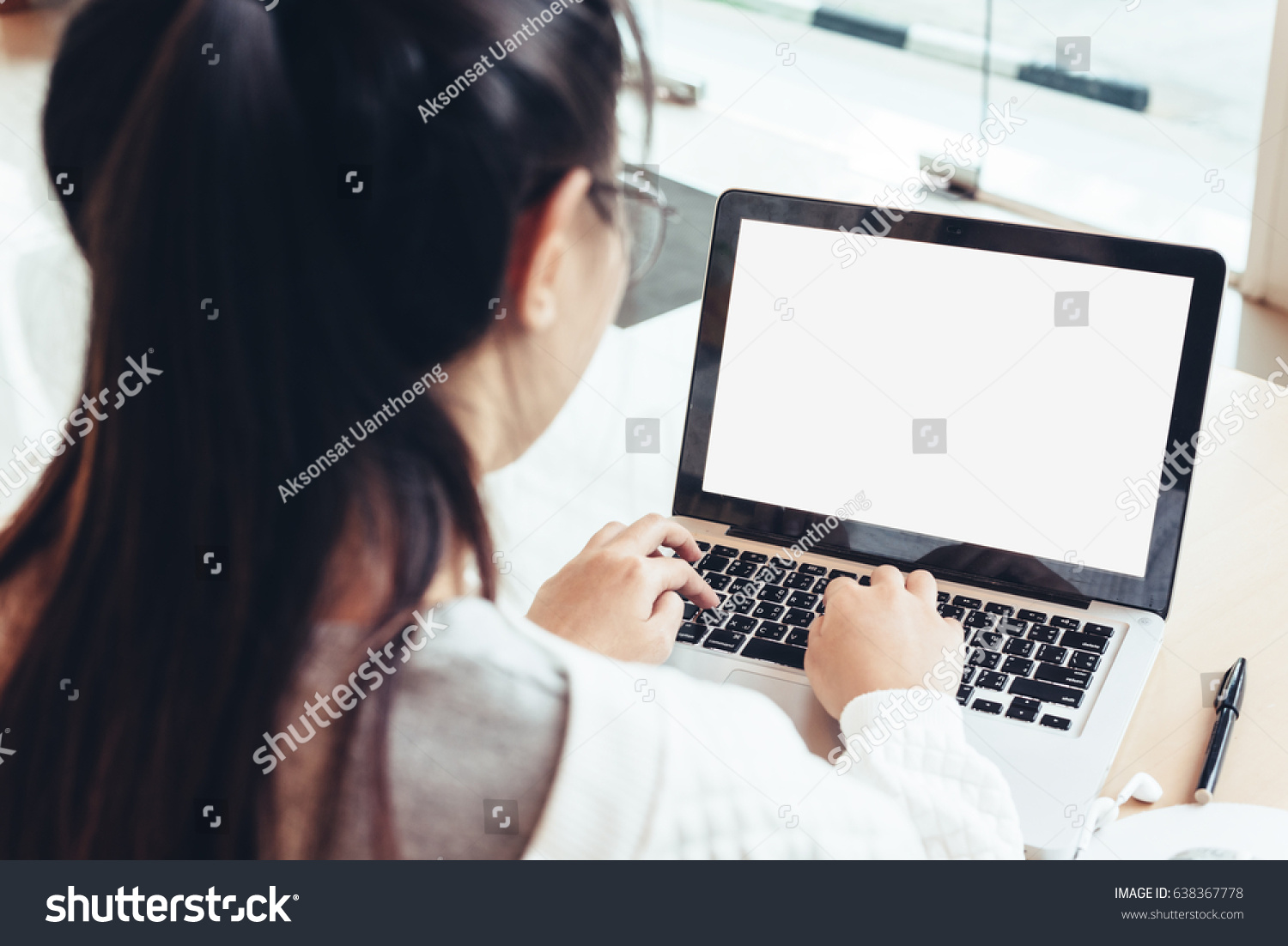 Businesswoman or women using laptop at cafe. Young beautiful girl sitting in a coffee shop and working on computer #638367778