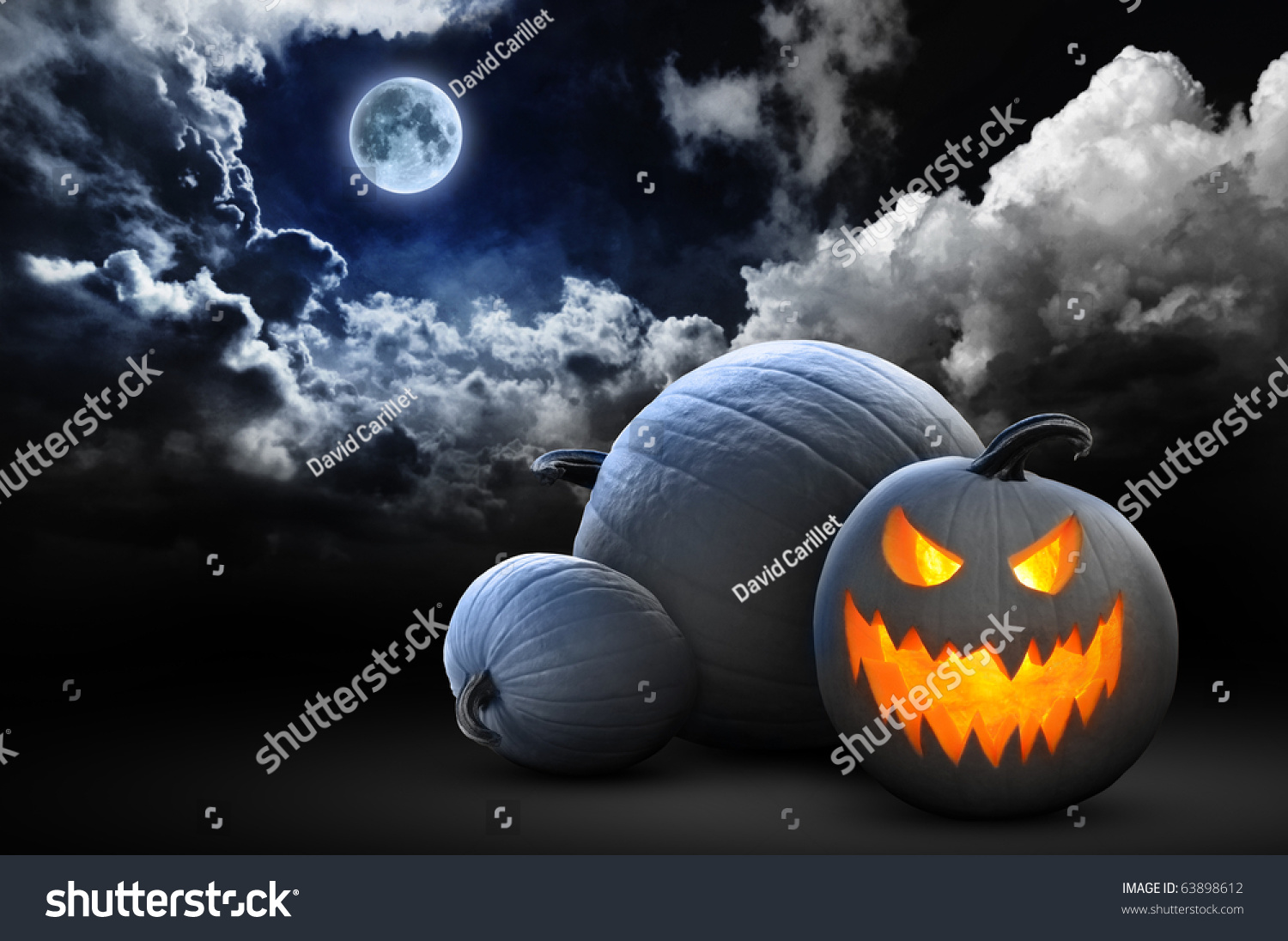 spooky halloween pumpkins under full moon #63898612