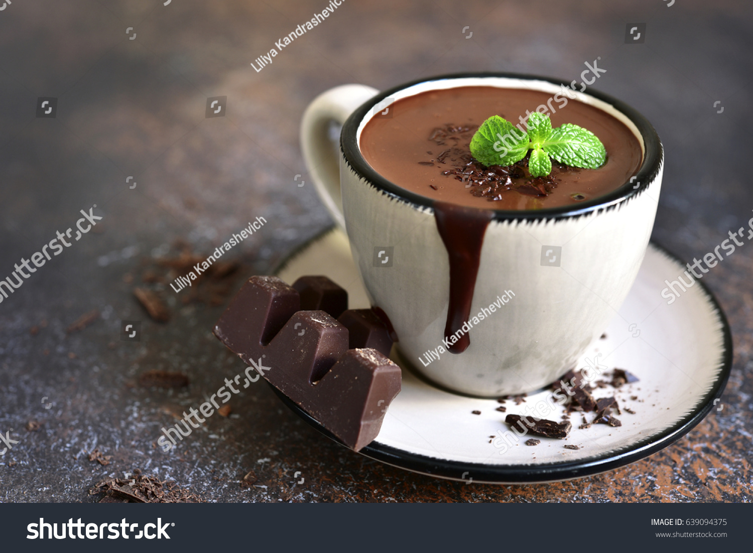 Portion of homemade mint hot chocolate in a cup on a dark slate,stone or metal background. #639094375