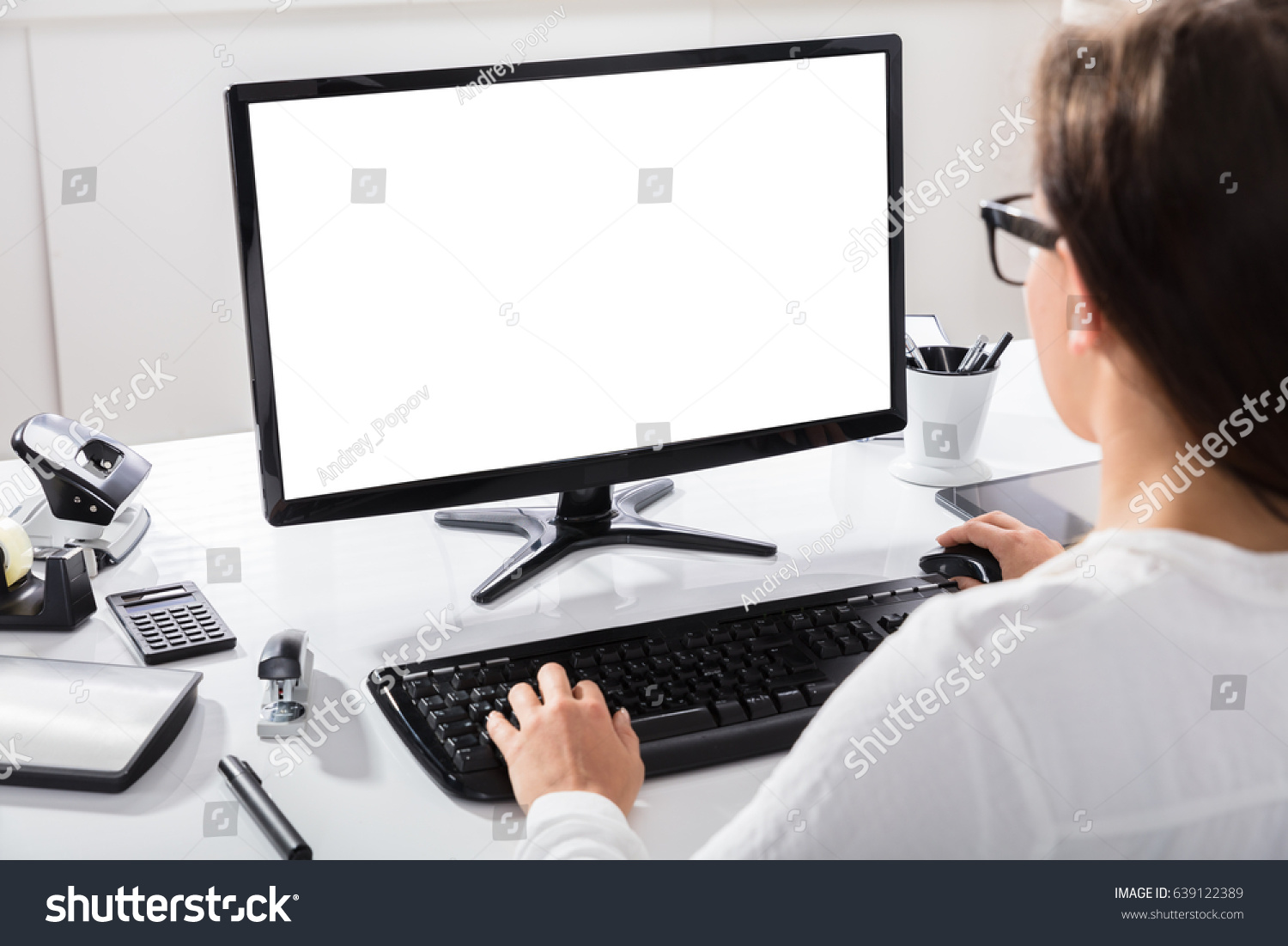 Close-up Of A Businesswoman Using Computer With Blank Screen At Workplace #639122389