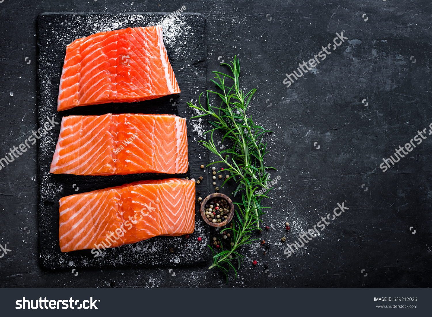 Raw salmon filet on dark slate background, wild atlantic fish #639212026