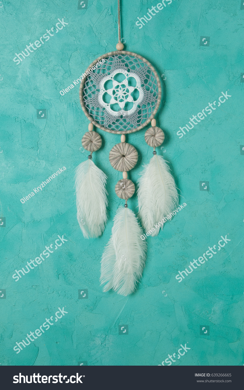 White gray dream catcher close up on aquamarine textured background. Copy space for text #639266665